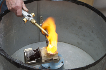 Using an acetylene torch to melt silver.